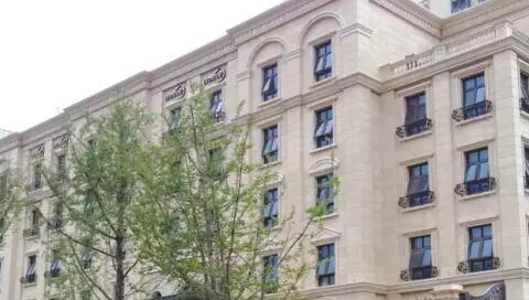 青岛凯旋花园黄金麻石材外墙装修实景效果图